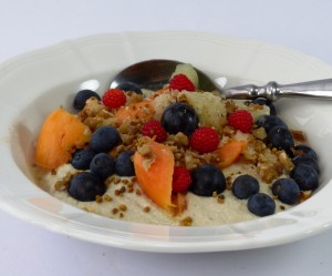 Budwig muesli made from Budwig cream with grated fresh ginger, papaya, grapefruit, mixed berries, ground linseed and nuts.